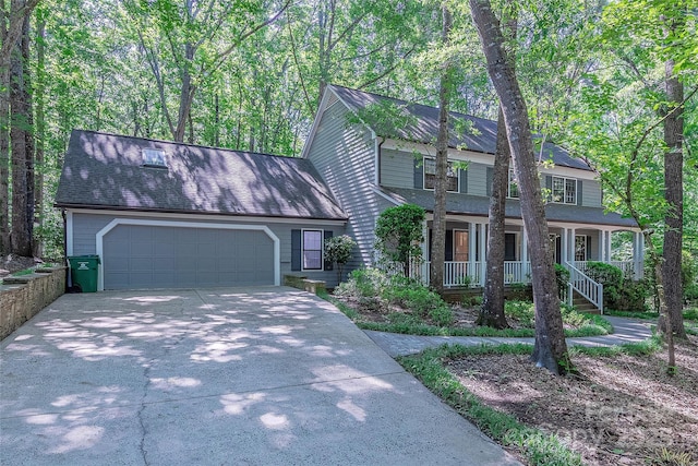2310 Vestry Pl, Charlotte, NC 28270 - view of front of house with driveway, a garage, covered porch, and roof with shingles