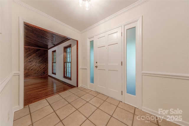 2310 Vestry Pl, Charlotte, NC 28270 - foyer entrance with wooden walls, light tile patterned floors, and ornamental molding