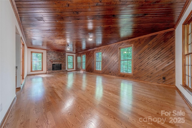 2310 Vestry Pl, Charlotte, NC 28270 - unfurnished living room featuring wooden ceiling, a fireplace, baseboards, wood finished floors, and wood walls