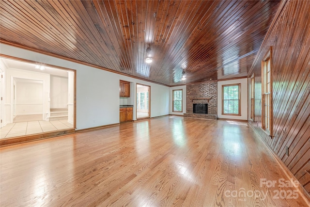 2310 Vestry Pl, Charlotte, NC 28270 - unfurnished living room featuring crown molding, wood ceiling, light wood-style flooring, a fireplace, and baseboards