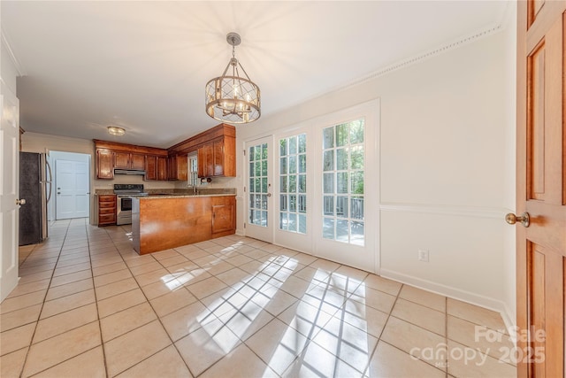 2310 Vestry Pl, Charlotte, NC 28270 - kitchen with appliances with stainless steel finishes, under cabinet range hood, light tile patterned flooring, a chandelier, and brown cabinetry