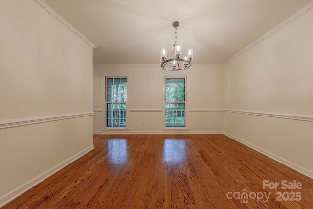 2310 Vestry Pl, Charlotte, NC 28270 - spare room with a chandelier, baseboards, wood finished floors, and crown molding
