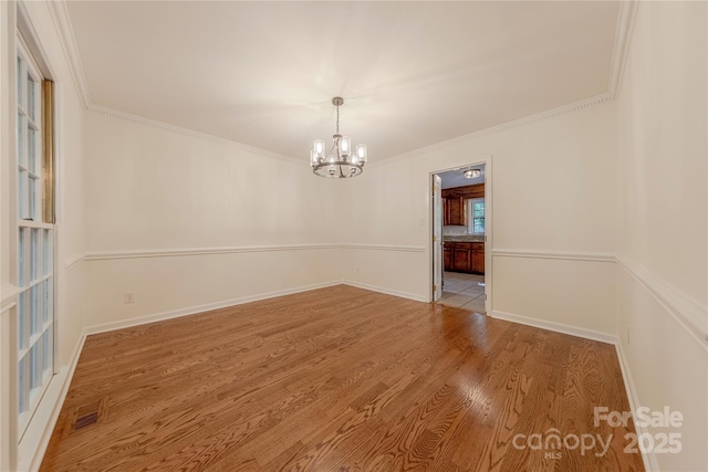 2310 Vestry Pl, Charlotte, NC 28270 - spare room with a chandelier, wood finished floors, ornamental molding, and baseboards