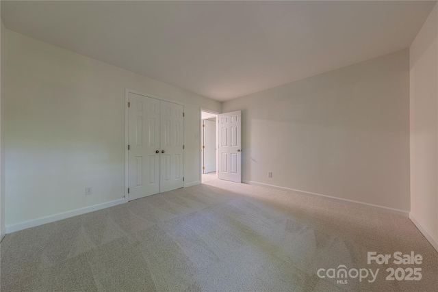 2310 Vestry Pl, Charlotte, NC 28270 - unfurnished bedroom featuring light colored carpet, baseboards, and a closet