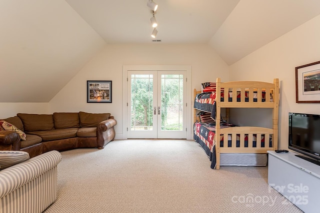 bedroom featuring lofted ceiling, carpet flooring, visible vents, track lighting, and access to outside