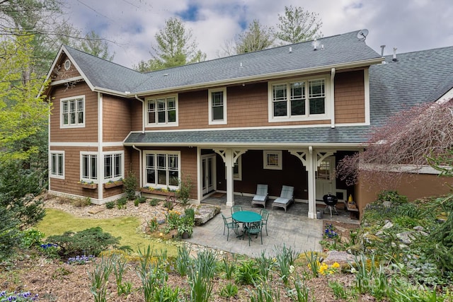 back of house featuring a shingled roof and a patio area