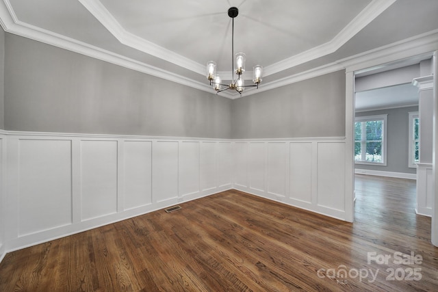 5633 Open Book Ln, Charlotte, NC 28270 - spare room with a chandelier, a tray ceiling, crown molding, dark wood-style floors, and a decorative wall