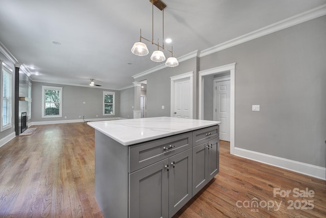 5633 Open Book Ln, Charlotte, NC 28270 - kitchen featuring gray cabinets, ornamental molding, ceiling fan, baseboards, and open floor plan
