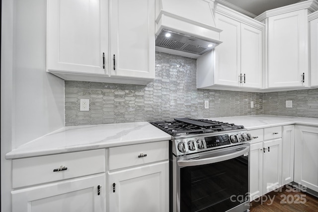 5633 Open Book Ln, Charlotte, NC 28270 - kitchen featuring stainless steel range with gas stovetop, white cabinetry, backsplash, light stone counters, and premium range hood
