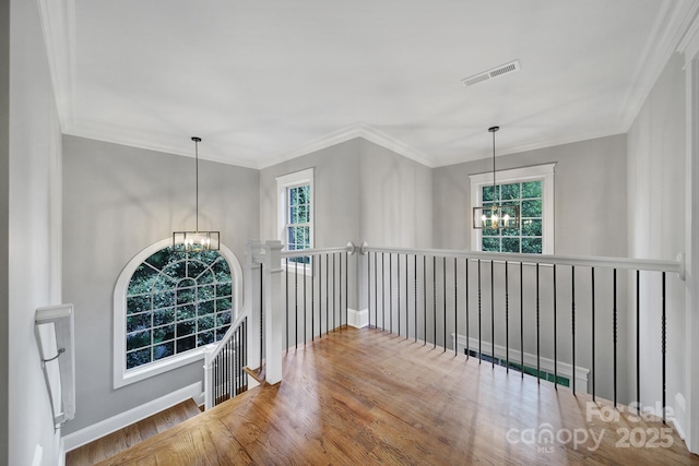 5633 Open Book Ln, Charlotte, NC 28270 - hall featuring a chandelier, plenty of natural light, an upstairs landing, wood finished floors, and crown molding
