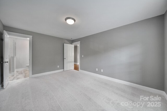 5633 Open Book Ln, Charlotte, NC 28270 - unfurnished bedroom featuring carpet, baseboards, and ensuite bathroom