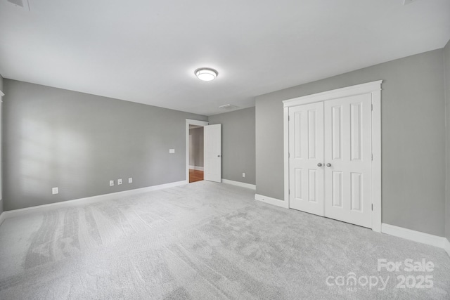5633 Open Book Ln, Charlotte, NC 28270 - unfurnished bedroom featuring baseboards, carpet flooring, and a closet
