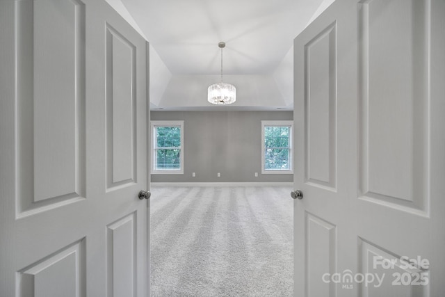 5633 Open Book Ln, Charlotte, NC 28270 - carpeted spare room with a tray ceiling, plenty of natural light, a chandelier, and baseboards