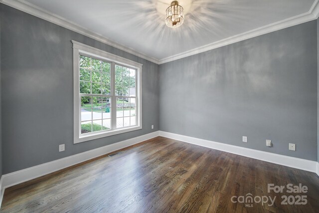 5633 Open Book Ln, Charlotte, NC 28270 - spare room featuring ornamental molding, baseboards, dark wood-type flooring, and a chandelier