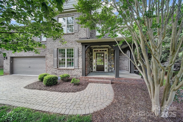 5633 Open Book Ln, Charlotte, NC 28270 - doorway to property with a porch, decorative driveway, and brick siding