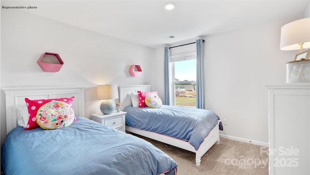 bedroom with carpet flooring and baseboards