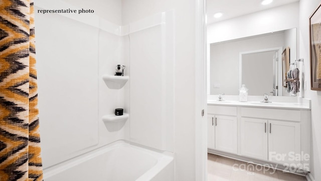 full bathroom featuring recessed lighting, double vanity, a sink, and washtub / shower combination