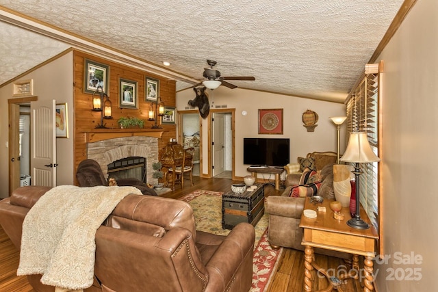 20 Howell Rd, Brevard, NC 28712 - living room with ornamental molding, ceiling fan, wood finished floors, a stone fireplace, and a textured ceiling