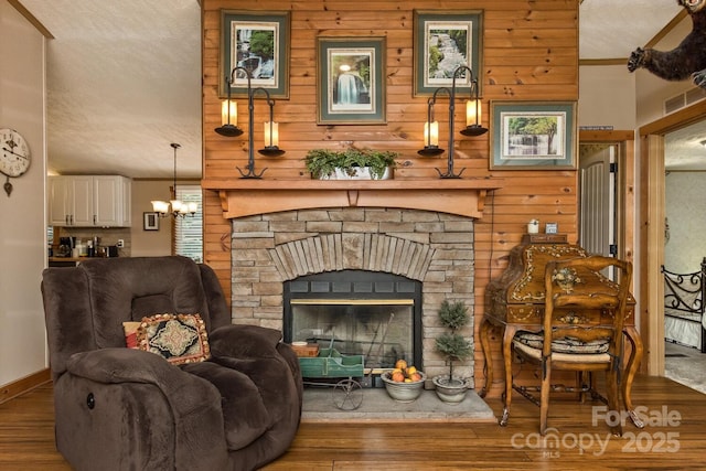 20 Howell Rd, Brevard, NC 28712 - living room featuring wood finished floors, wood walls, a chandelier, and baseboards
