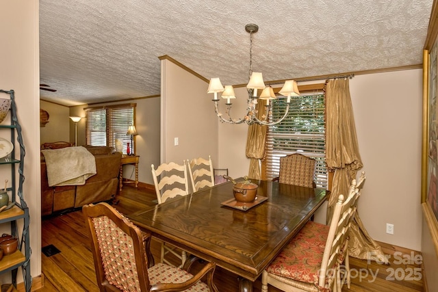 20 Howell Rd, Brevard, NC 28712 - dining space featuring crown molding, a chandelier, wood finished floors, and a textured ceiling