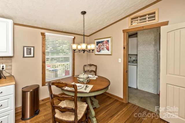 20 Howell Rd, Brevard, NC 28712 - dining space with lofted ceiling, washer / clothes dryer, ornamental molding, a textured ceiling, and wood finished floors