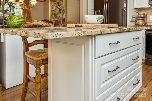 20 Howell Rd, Brevard, NC 28712 - detailed view of wood finished floors, stainless steel appliances, a chandelier, and backsplash