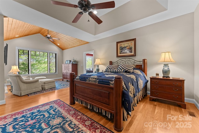bedroom featuring multiple windows, light wood-type flooring, wooden ceiling, baseboards, and lofted ceiling