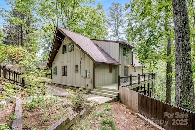 8 Quinn Ct, Asheville, NC 28805 - back of house featuring a shingled roof, a wooden deck, and fence