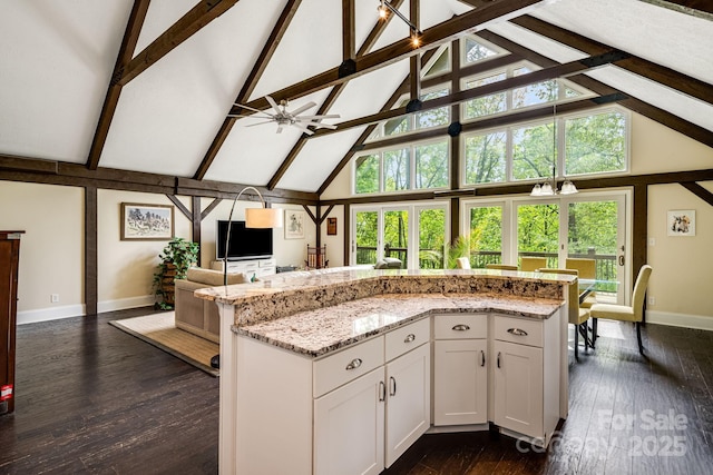 8 Quinn Ct, Asheville, NC 28805 - kitchen featuring high vaulted ceiling, open floor plan, baseboards, plenty of natural light, and white cabinetry