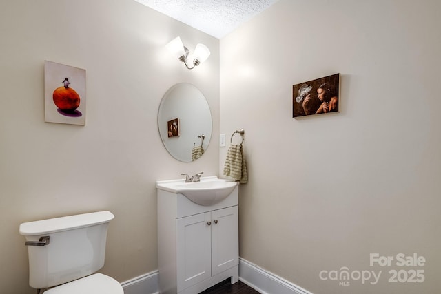 8 Quinn Ct, Asheville, NC 28805 - half bathroom with baseboards, vanity, toilet, and a textured ceiling