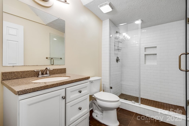8 Quinn Ct, Asheville, NC 28805 - full bath featuring a stall shower, toilet, tile patterned floors, a textured ceiling, and vanity
