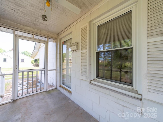 unfurnished sunroom with a ceiling fan