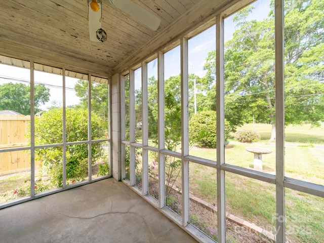 unfurnished sunroom with a ceiling fan