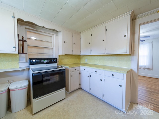kitchen with white cabinetry, light countertops, white electric range, and decorative backsplash