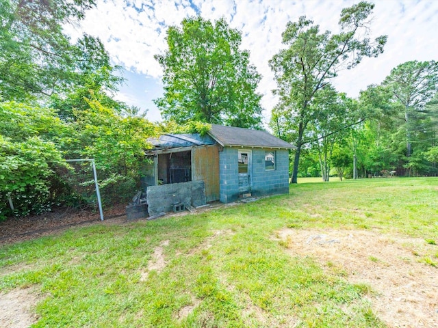 exterior space with an outdoor structure and a lawn