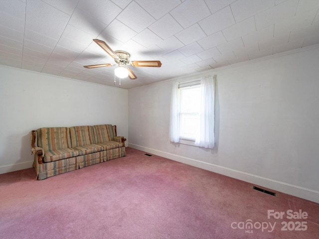 unfurnished room with carpet flooring, visible vents, baseboards, and ceiling fan