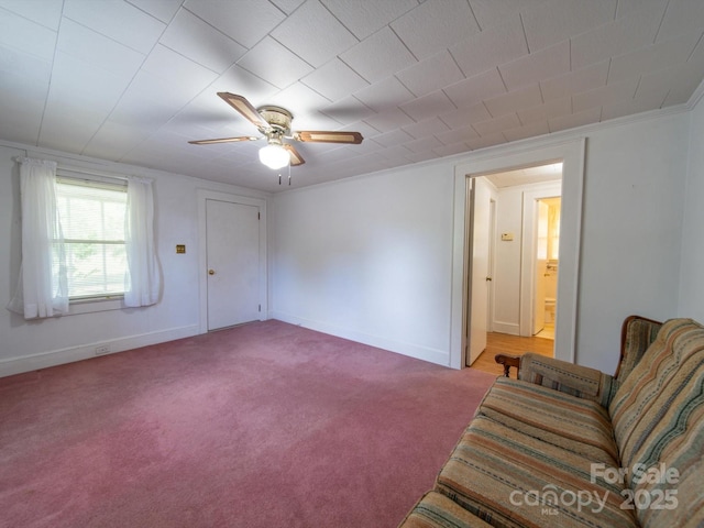 unfurnished living room with ceiling fan, light colored carpet, and baseboards