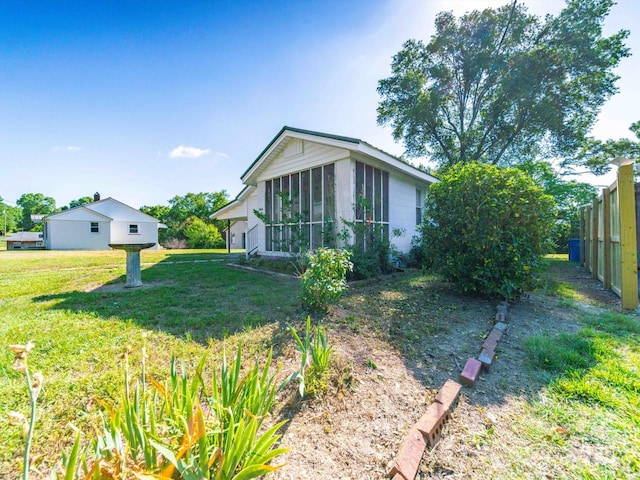 exterior space with a sunroom and fence