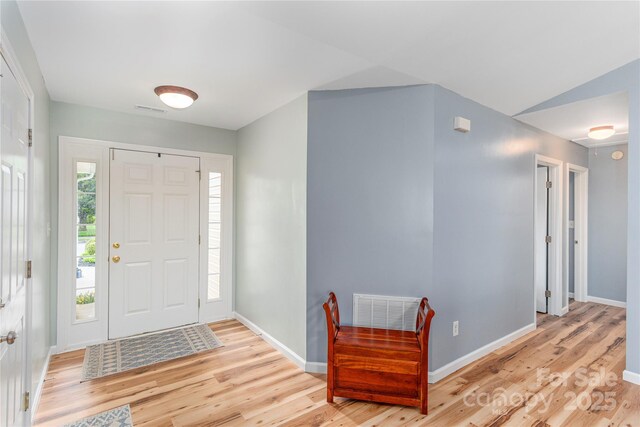 entryway with light wood-style flooring and baseboards