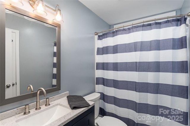 full bathroom with toilet, vanity, and curtained shower