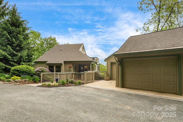 61 Ivy Ridge Rd, Burnsville, NC 28714 - view of front facade with a garage and a shingled roof