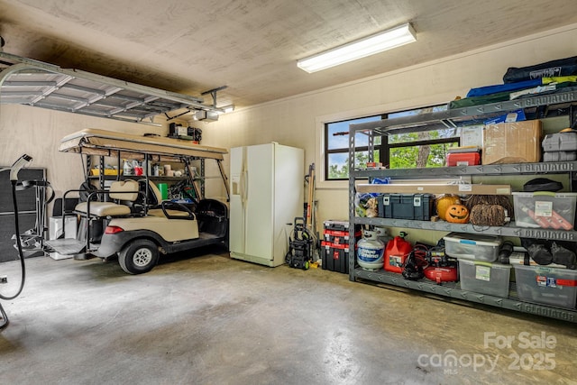 61 Ivy Ridge Rd, Burnsville, NC 28714 - garage with white fridge with ice dispenser and a garage door opener
