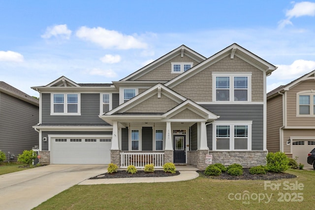 craftsman-style house with stone siding, covered porch, an attached garage, and concrete driveway