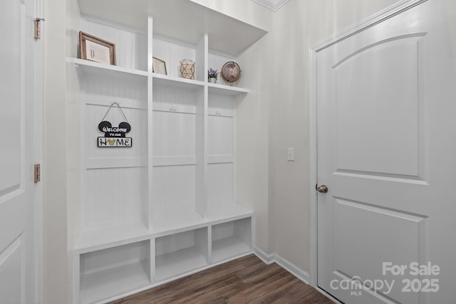mudroom featuring dark wood-type flooring and baseboards