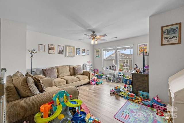 game room with ceiling fan and wood finished floors