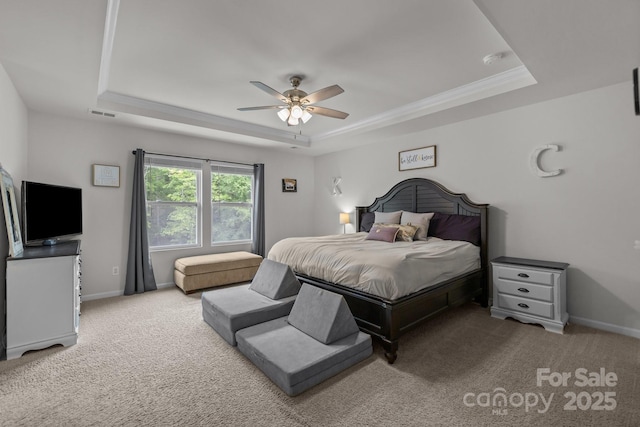 bedroom featuring a raised ceiling, carpet flooring, baseboards, and ceiling fan
