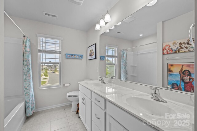 bathroom featuring toilet, baseboards, tile patterned flooring, double vanity, and shower / tub combo with curtain