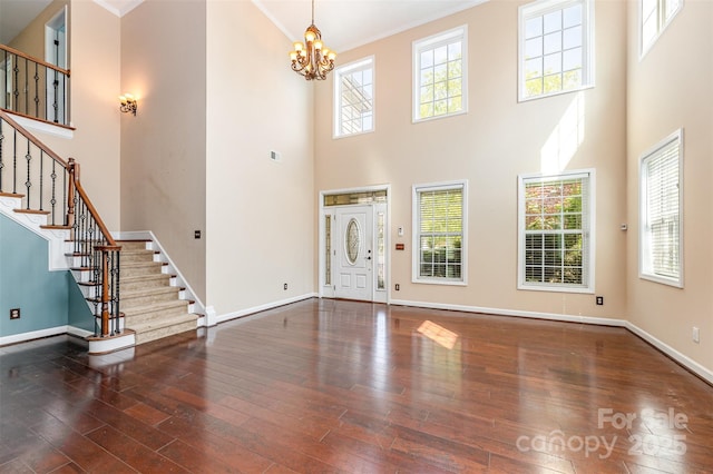 4504 Rockland Ct, High Point, NC 27265 - foyer featuring hardwood / wood-style floors, stairs, baseboards, a chandelier, and a high ceiling