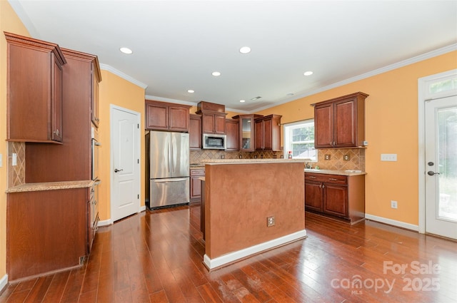 4504 Rockland Ct, High Point, NC 27265 - kitchen with stainless steel appliances, crown molding, tasteful backsplash, dark wood-style floors, and a center island