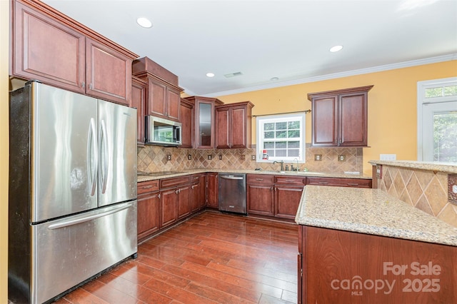 4504 Rockland Ct, High Point, NC 27265 - kitchen with stainless steel appliances, dark wood-style floors, light stone counters, decorative backsplash, and ornamental molding